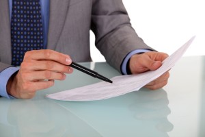 businessman scanning a document for anti-poaching agreement